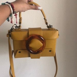 Yellow crossbody purse.